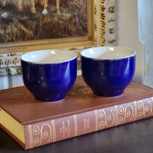 Load image into Gallery viewer, Hand Painted Cobalt Blue Porcelain Teacups with Crane in Flight and Gold Gilding - Set of 2
