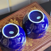 Load image into Gallery viewer, Hand Painted Cobalt Blue Porcelain Teacups with Crane in Flight and Gold Gilding - Set of 2