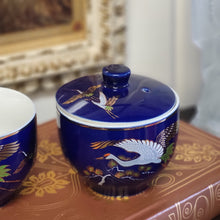 Load image into Gallery viewer, Hand Painted Cobalt Blue Porcelain Teacups with Crane in Flight and Gold Gilding - Set of 2