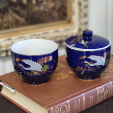 Load image into Gallery viewer, Hand Painted Cobalt Blue Porcelain Teacups with Crane in Flight and Gold Gilding - Set of 2