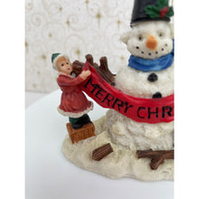 Load image into Gallery viewer, Snowman Figurine - Children Building a Snowman Holding a Merry Christmas Banner