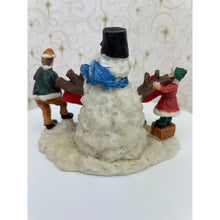 Load image into Gallery viewer, Snowman Figurine - Children Building a Snowman Holding a Merry Christmas Banner