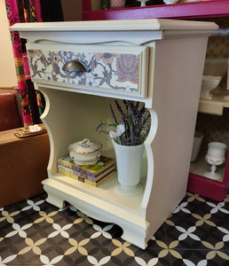 Cream colored Nightstand with botanical drawer front